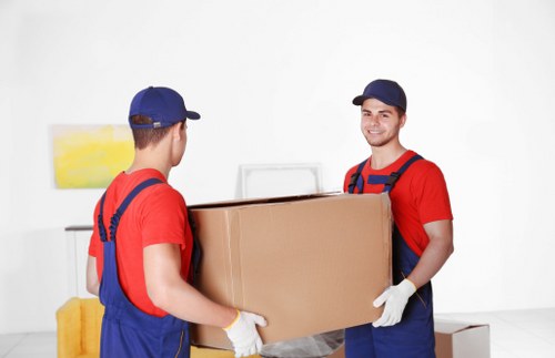 Mover wearing gloves and high-visibility clothing handling boxed items