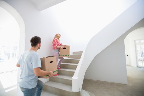 Careful lifting of furniture through a stairwell during a flat move